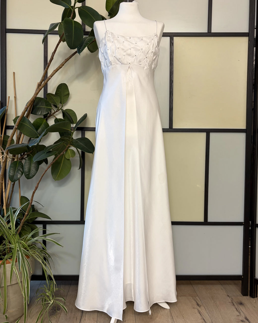 A white dress made of shimmering fabric