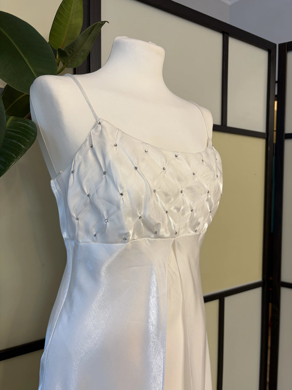 A white dress made of shimmering fabric