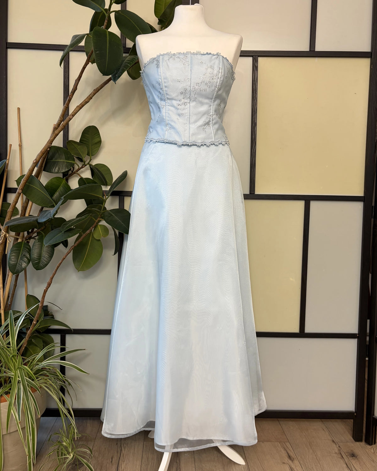 A blue dress with a wide skirt supported by a petticoat and a glitter-embellished bodice