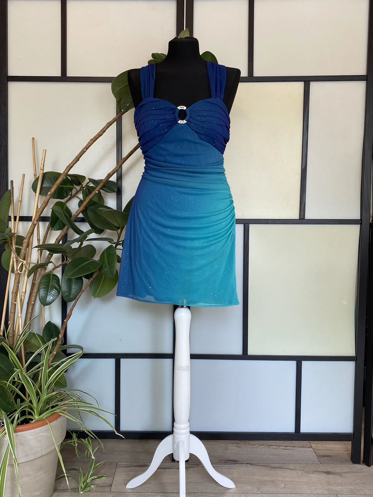 A sea blue dress transitioning into darker tones