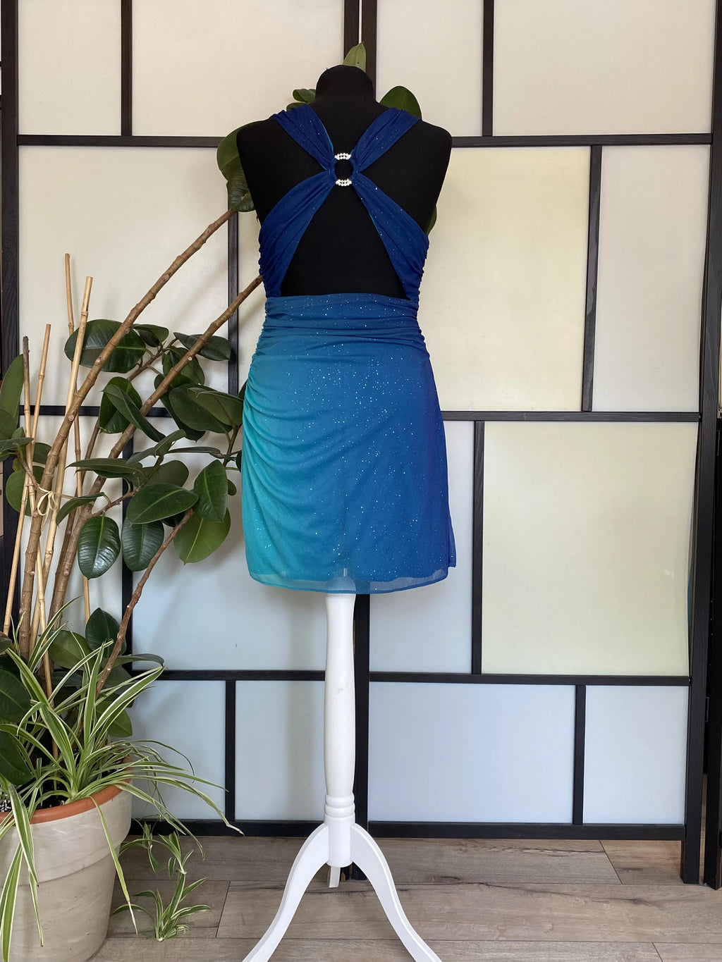 A sea blue dress transitioning into darker tones