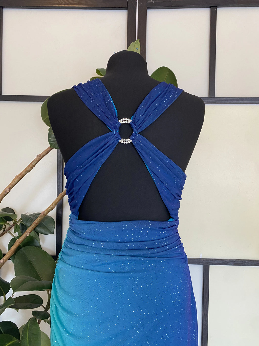 A sea blue dress transitioning into darker tones