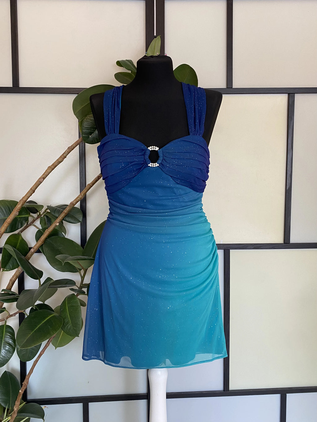 A sea blue dress transitioning into darker tones