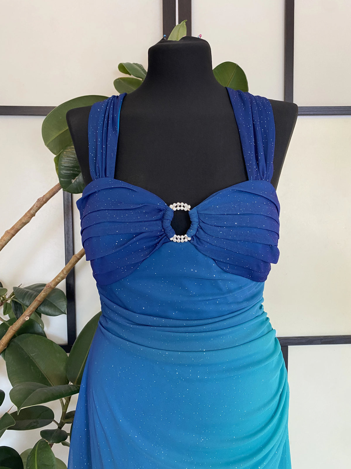 A sea blue dress transitioning into darker tones