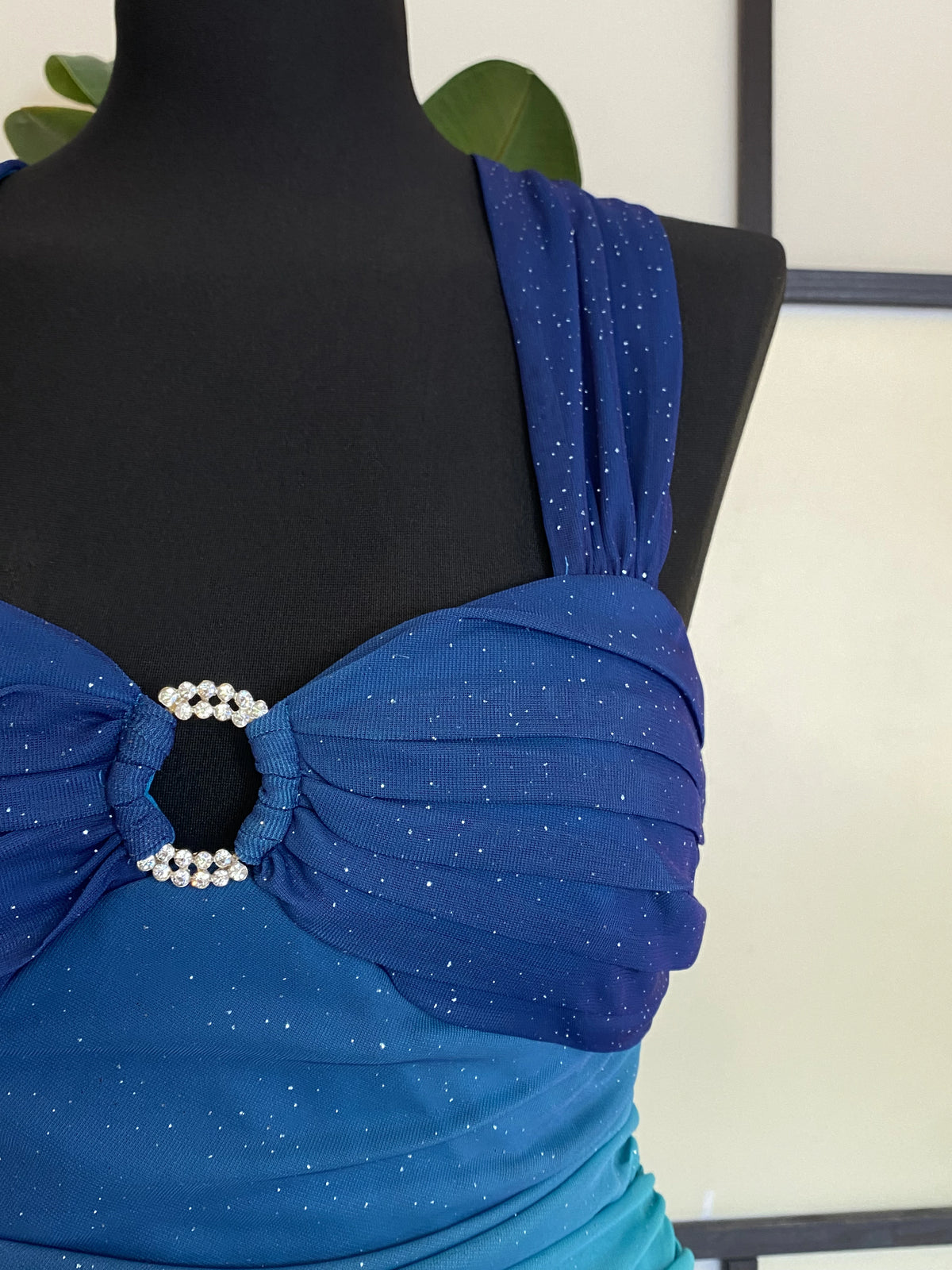 A sea blue dress transitioning into darker tones